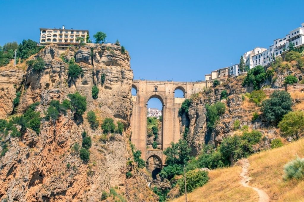 spanish city and bridge over deep gorge in mountains