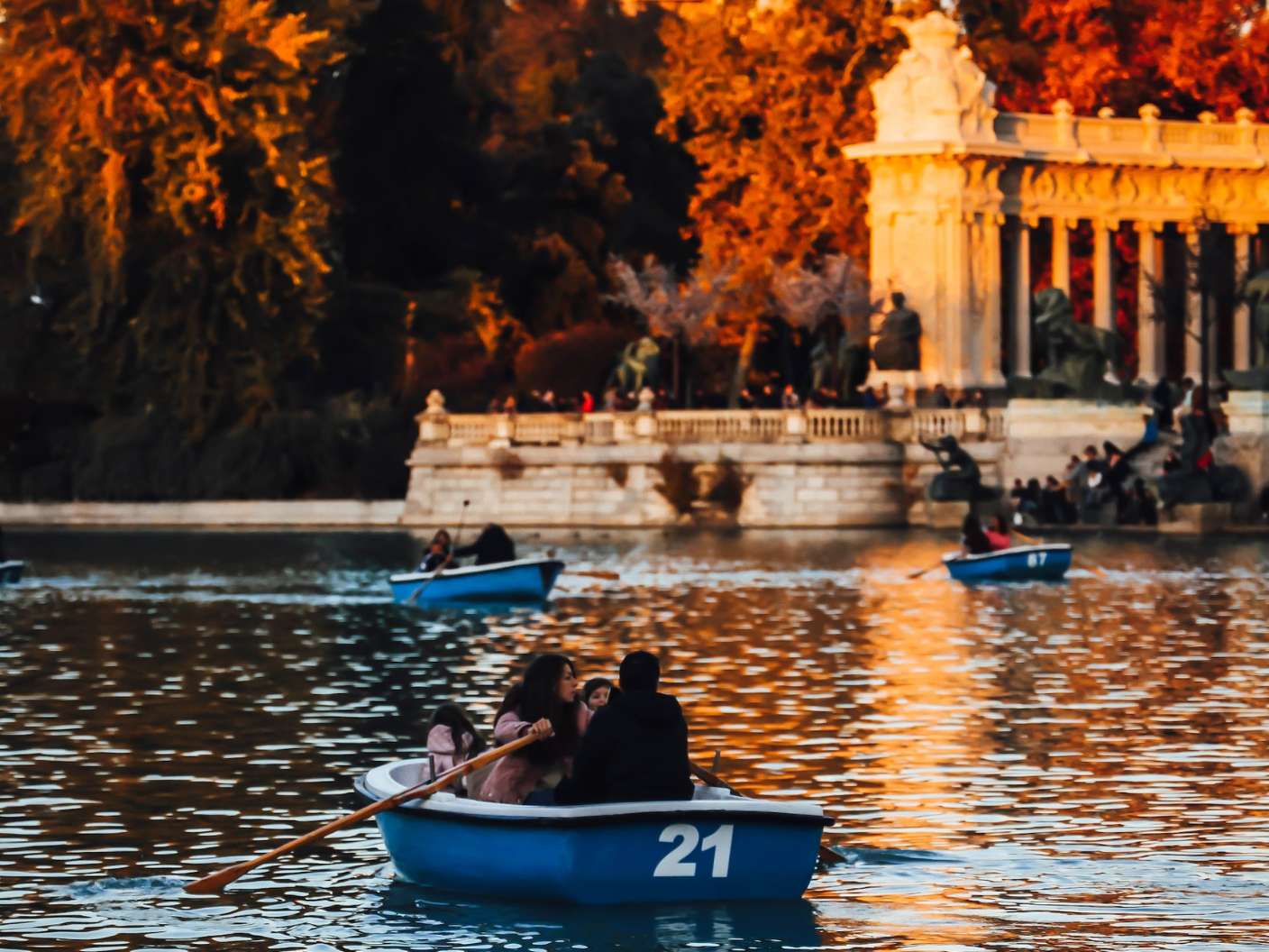 Family in a rowboat on the lake in Madrid