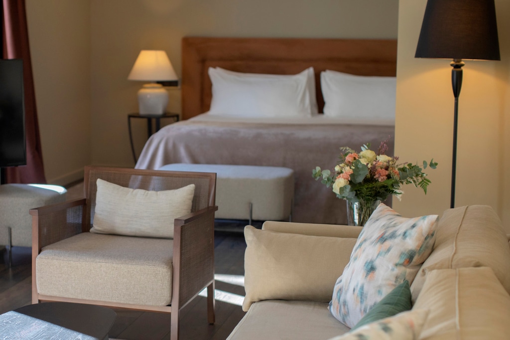 Bed and chair in El Llorenc Hotel in Mallorca, Spain