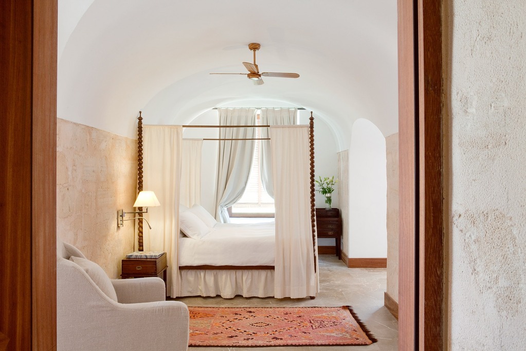 Hotel room of Cap Rocat in Spain with white linen and brown accents