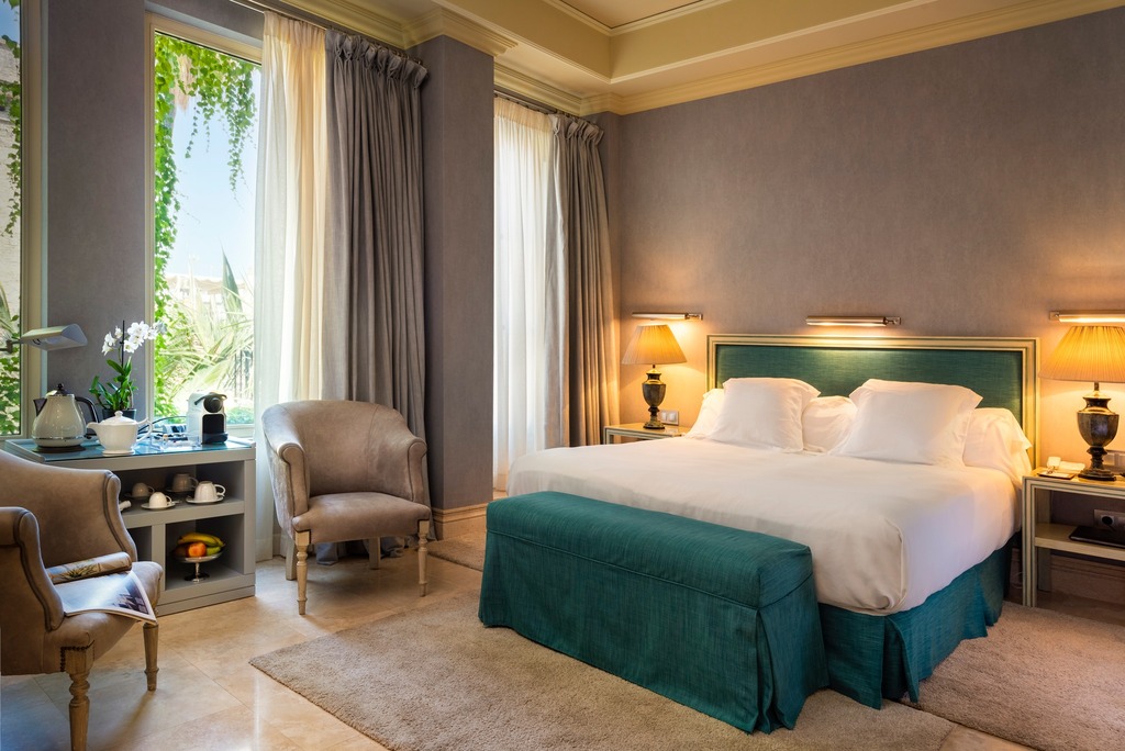 Hotel room of Casa del Poeta in Spain with white and blue accents