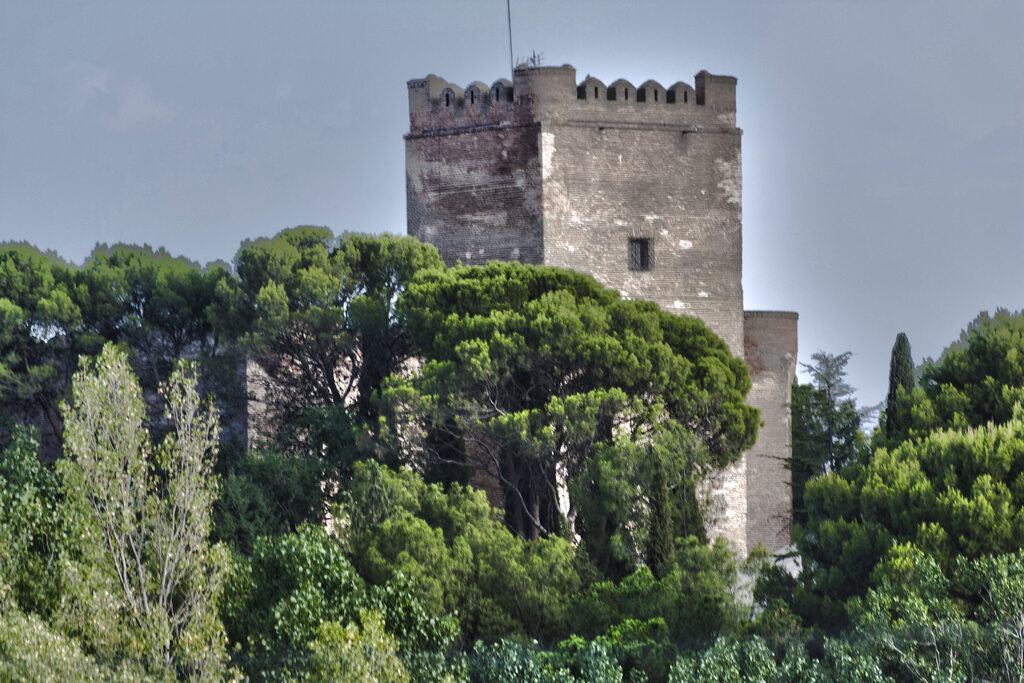 A view of the tower of the Castle of Batres through the trees in Spain