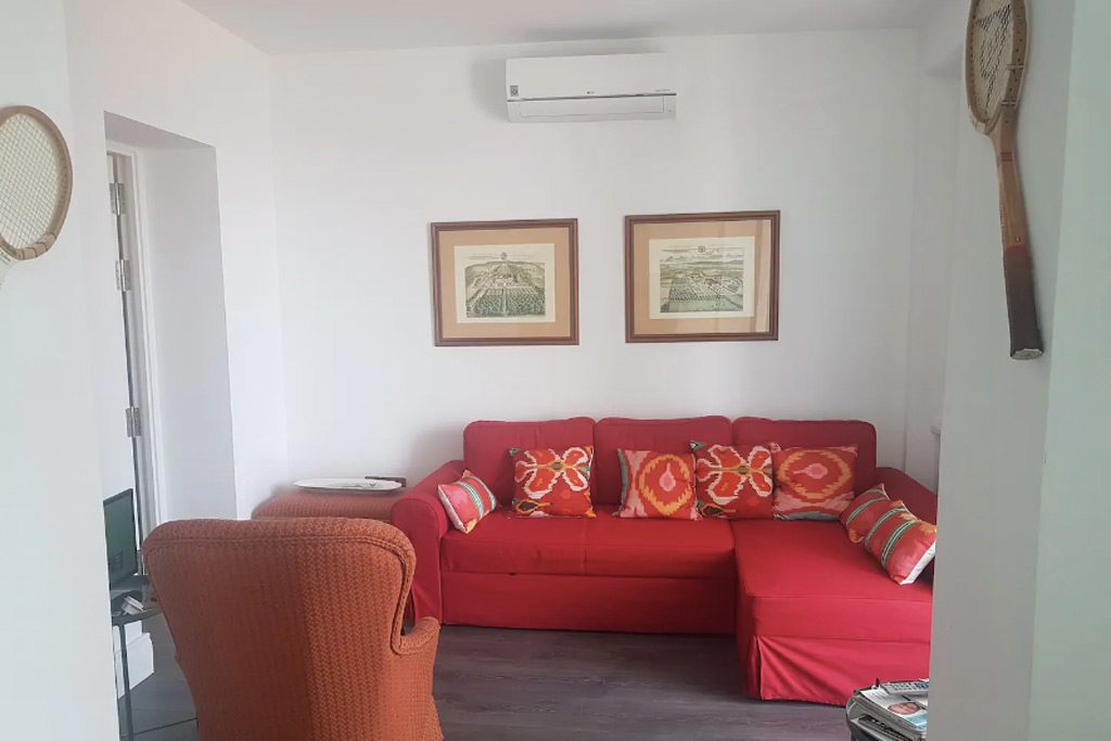 red couch in lounge of colonial apartment in Andalusia