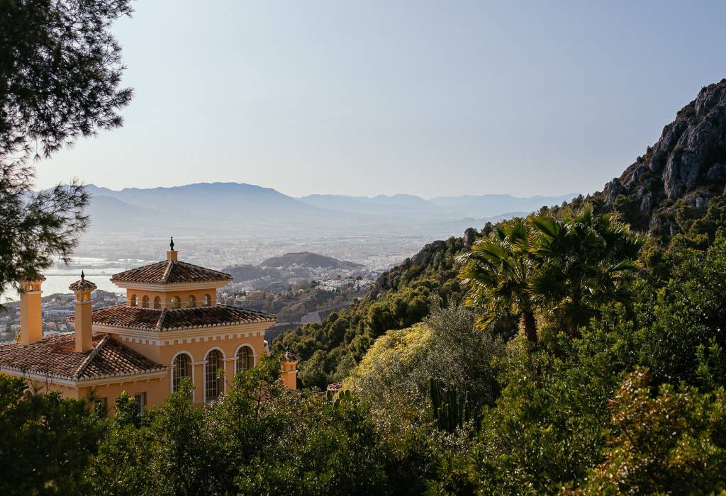 View of Malaga City with a green hill.