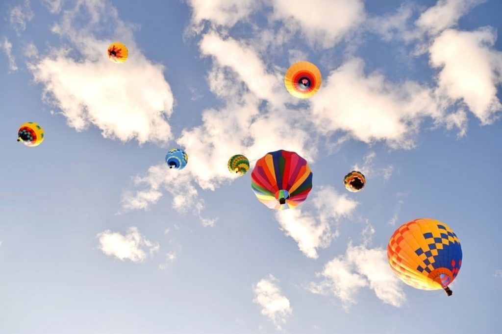 hot air balloons and clouds in the sky