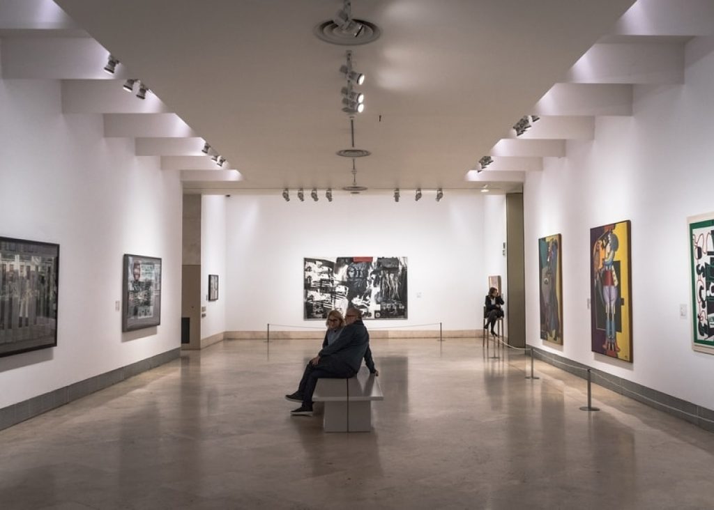 Couple looking at art inside museum