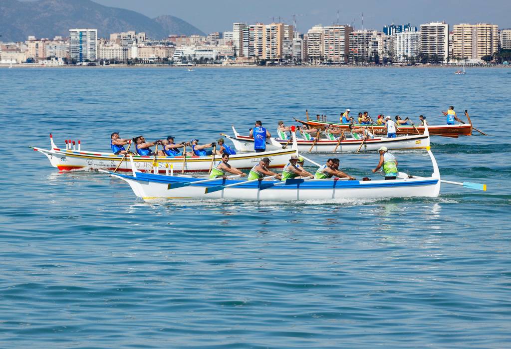 Team of people in a traditional rowing boat in the sea