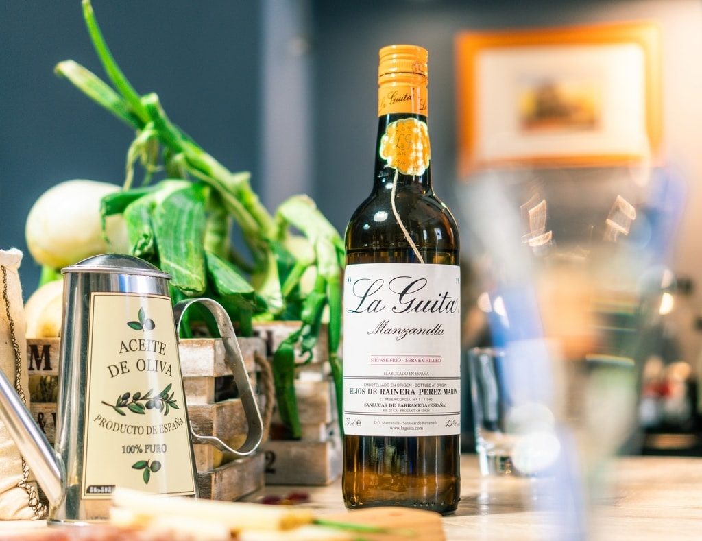 la-guita-manzanillo-bottle-standing-next-to-olive-oil-before-dinner-preperations