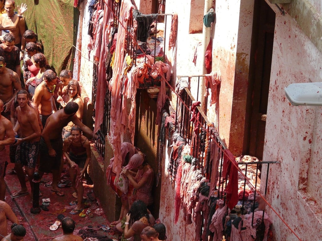La Tomatina, the tomato festival with people and buildings covered in tomato
