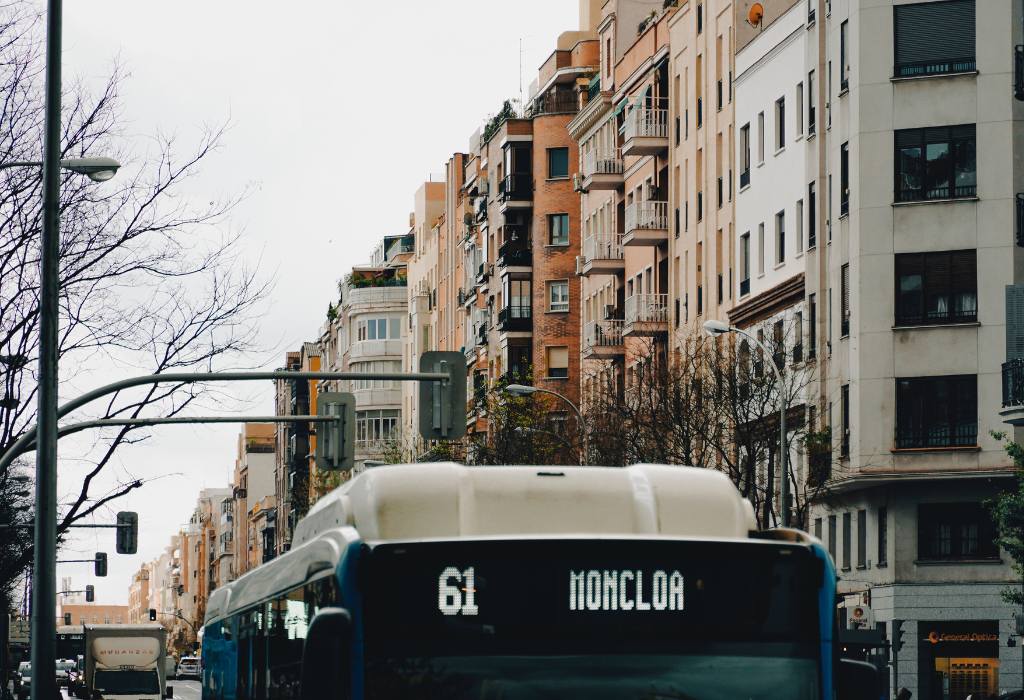 Picture of the top of a bus in the city.