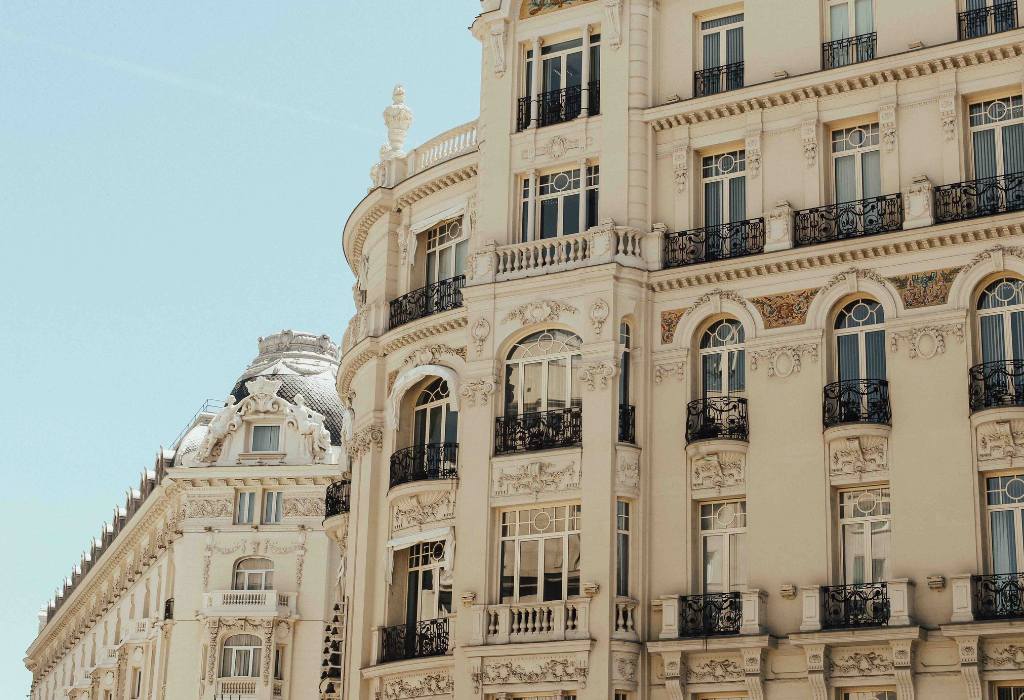 Cream building with wrought iron balconies.