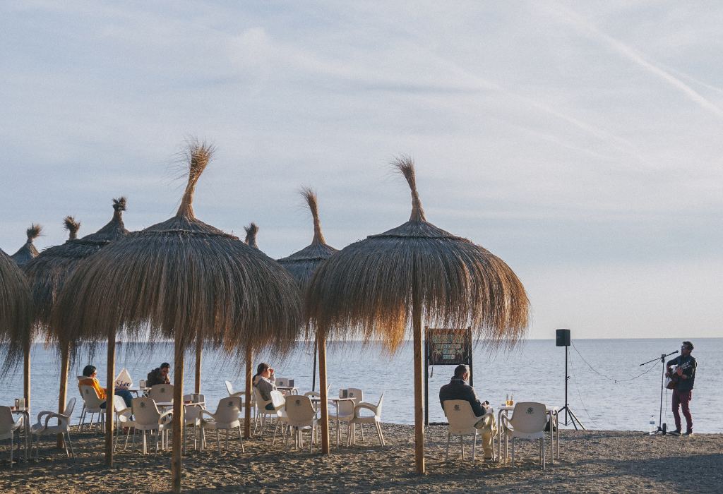 Grass umbrellas on the beach at sunset