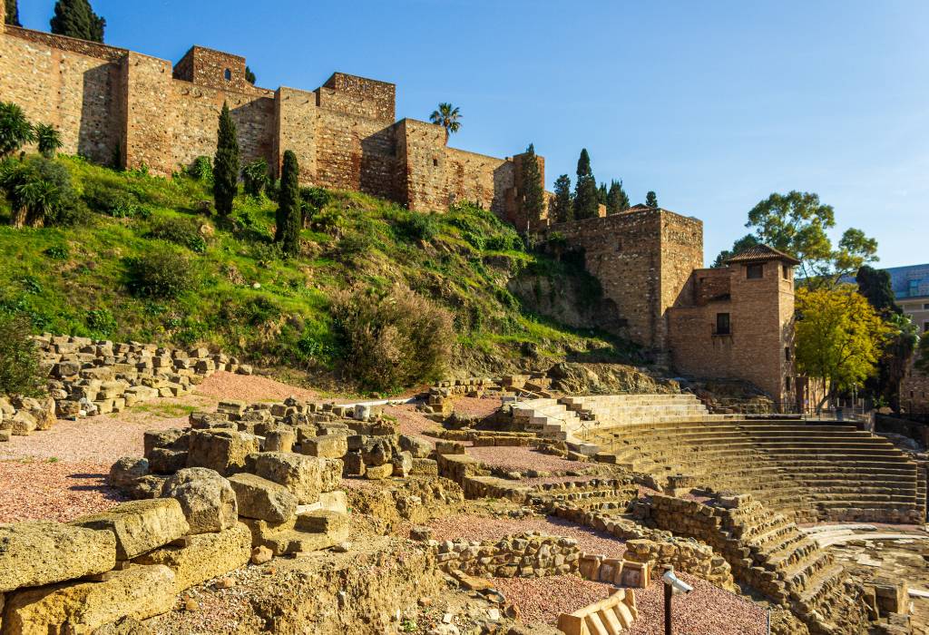 Ancient castle in Malaga with trees.