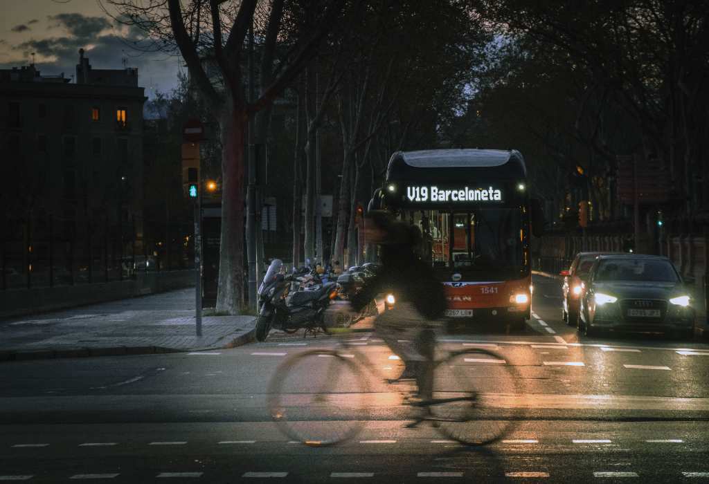 Man on a bike on the street at night.