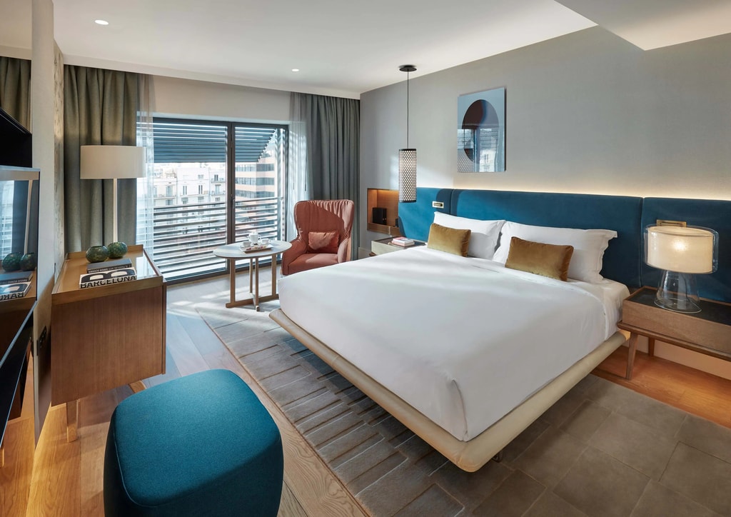 Mandarin Oriental Barcelona room with white bed and blue accents