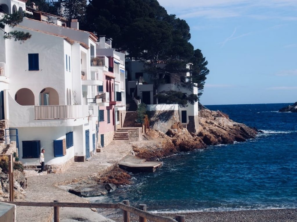 White-washed-homes-on-the-shoreline-of-Sa-Tuna-beach-Costa-Brava