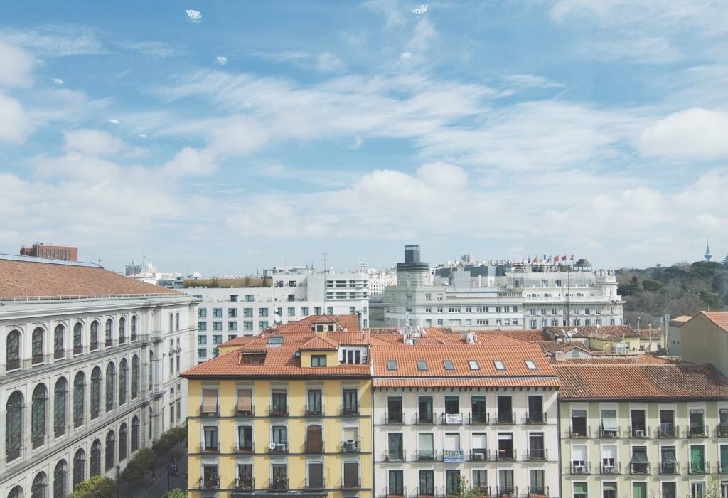 Yellow and white buildings with red roofs.