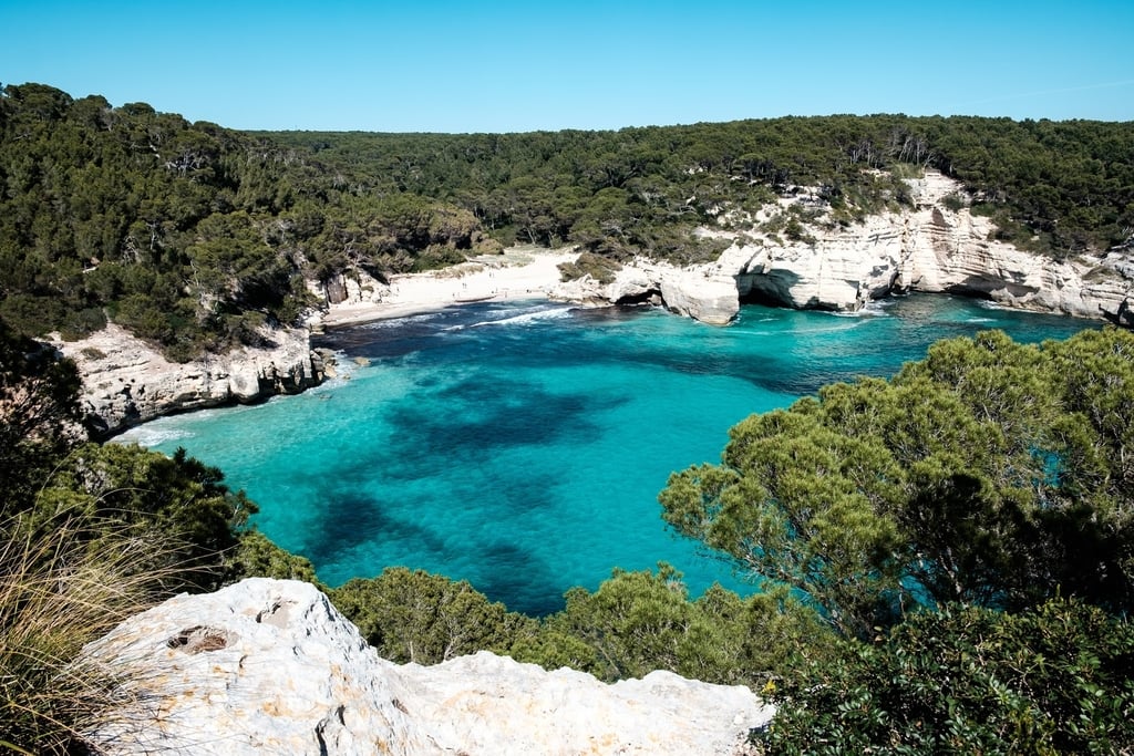 Secluded cove with turquoise waters in Menorca, Spain