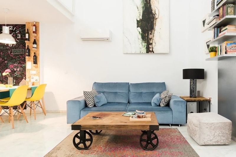 Blue couch in sophisticated Airbnb loft in the heart of Seville