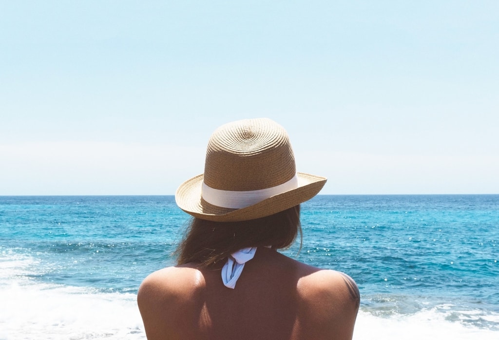 A woman sitting on the beach in Spain