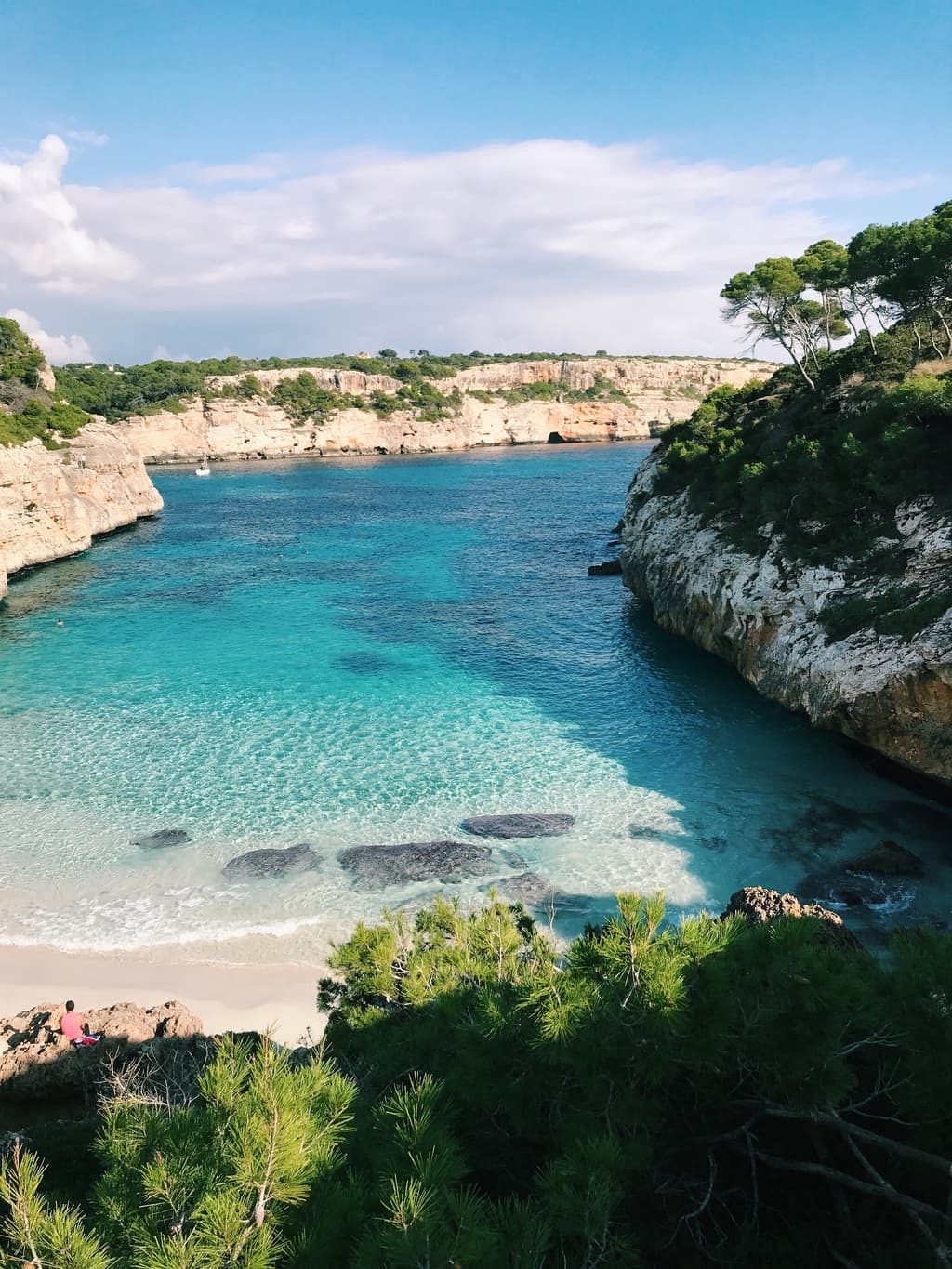 Beach in Spain, blue water, white sand, trees