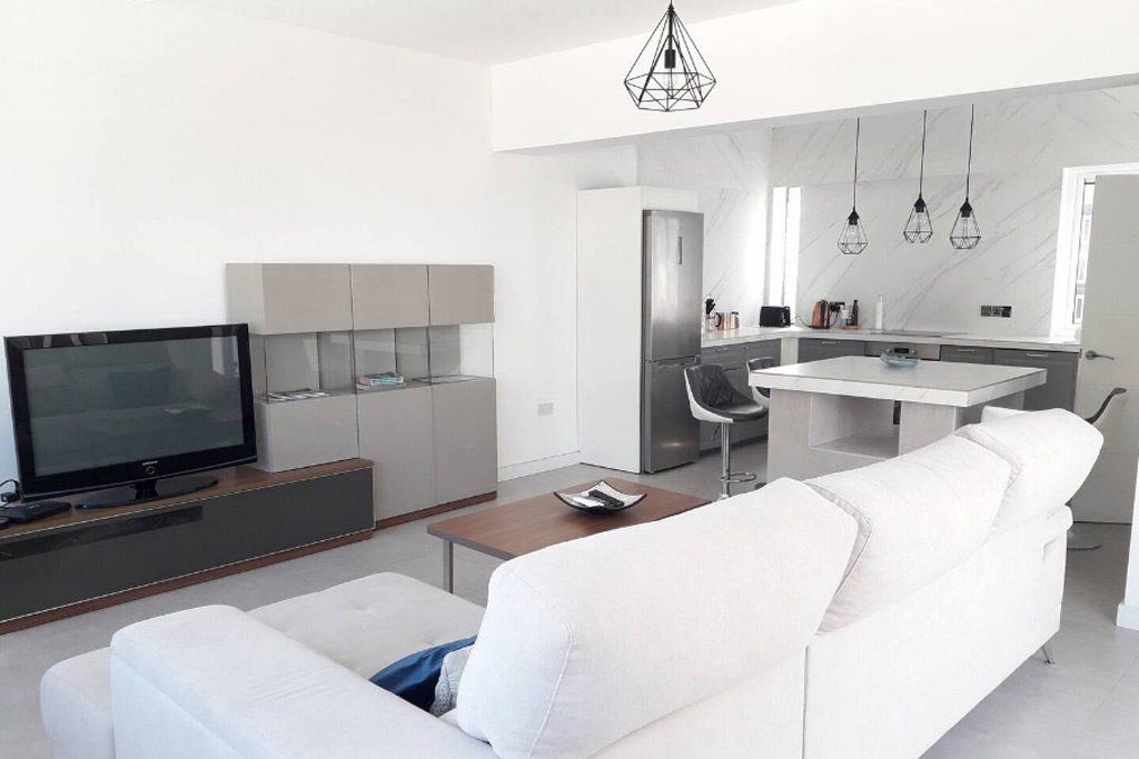 Clean white couch in penthouse apartment