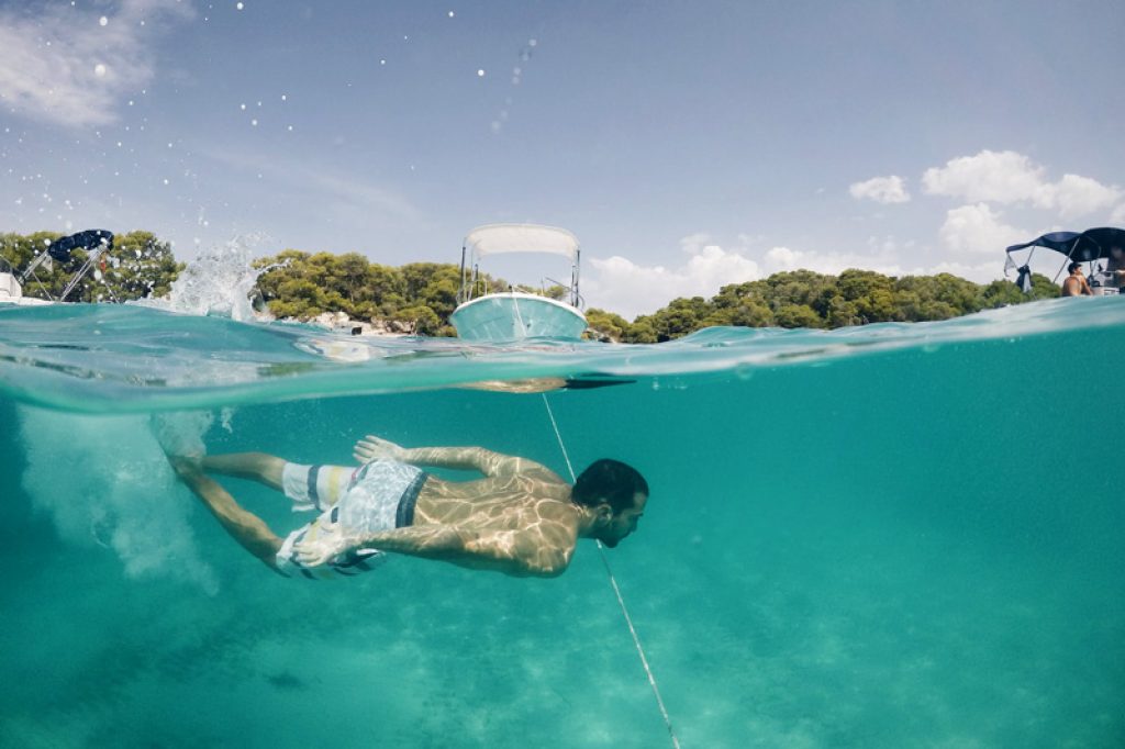 swimmer and boat menorca