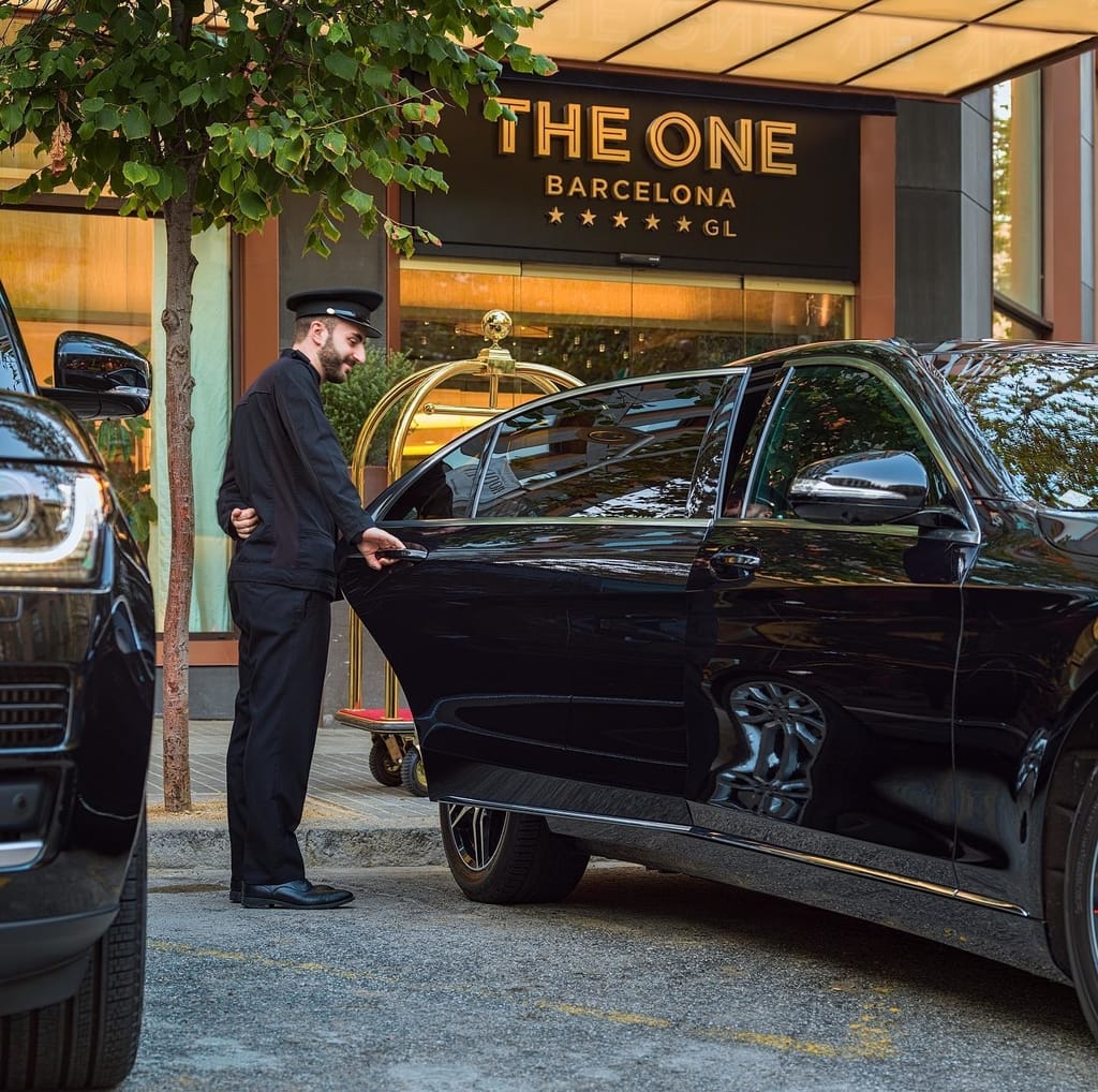 Front of The One Barcelona hotel with doorman opening car door
