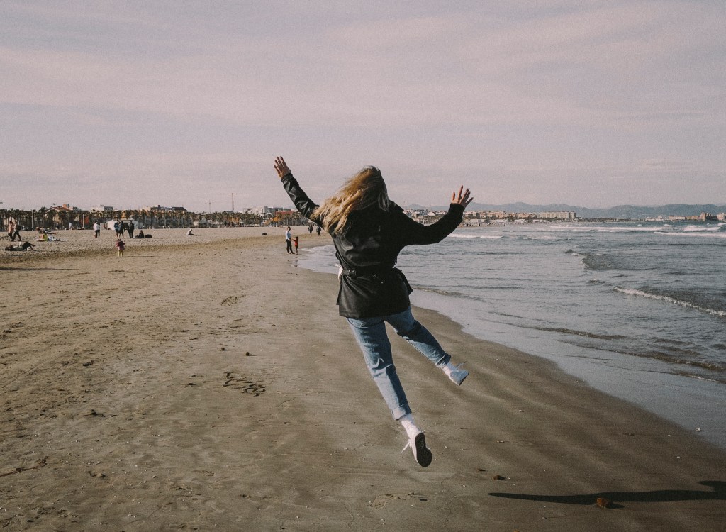 Tourist wearing winter clothes at a beach in Valencia