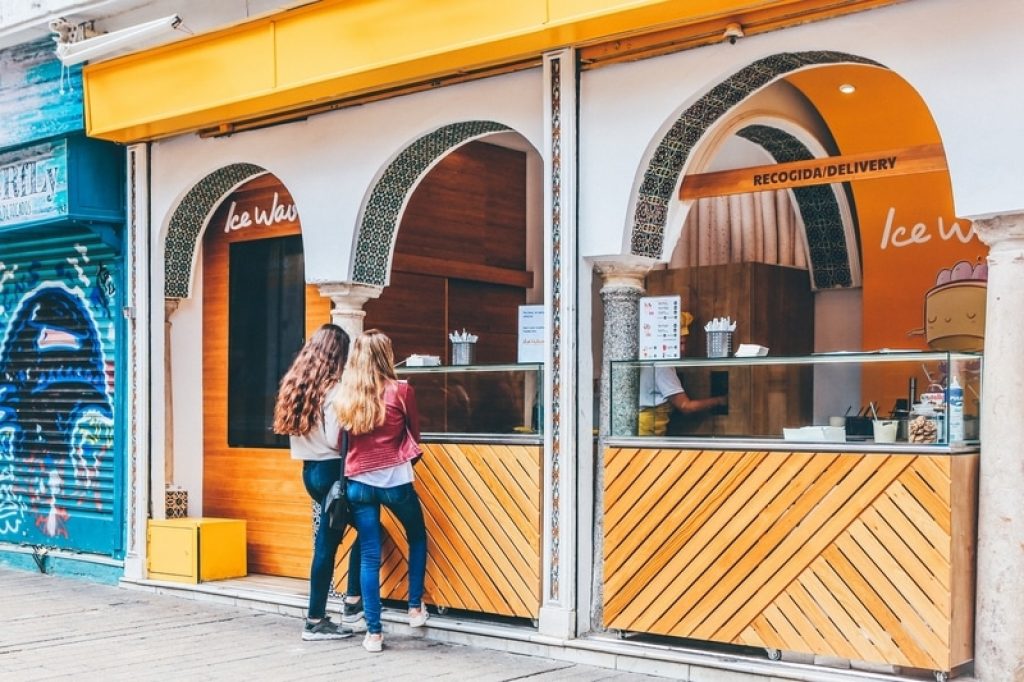Two ladies standing outside an ice cream shop in spain