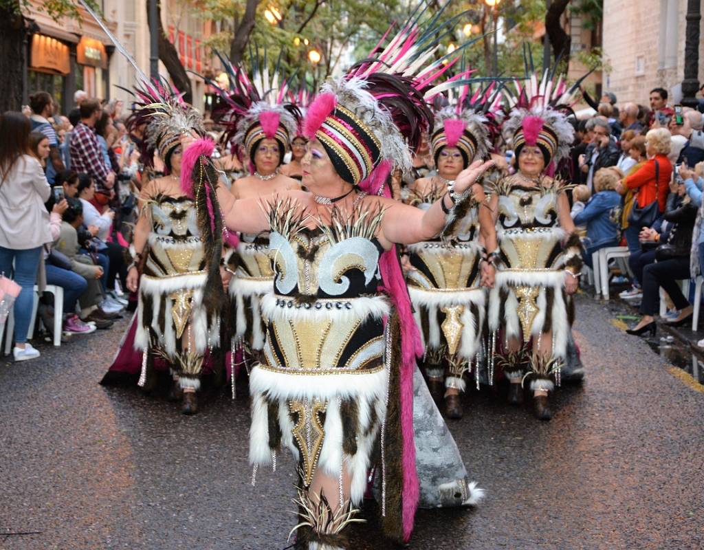 Women in traditional outfits dancing in street parade in Valencia