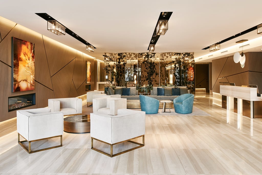 Lobby area of VP Plaza Espana Design Hotel in Madrid with white and blue chairs