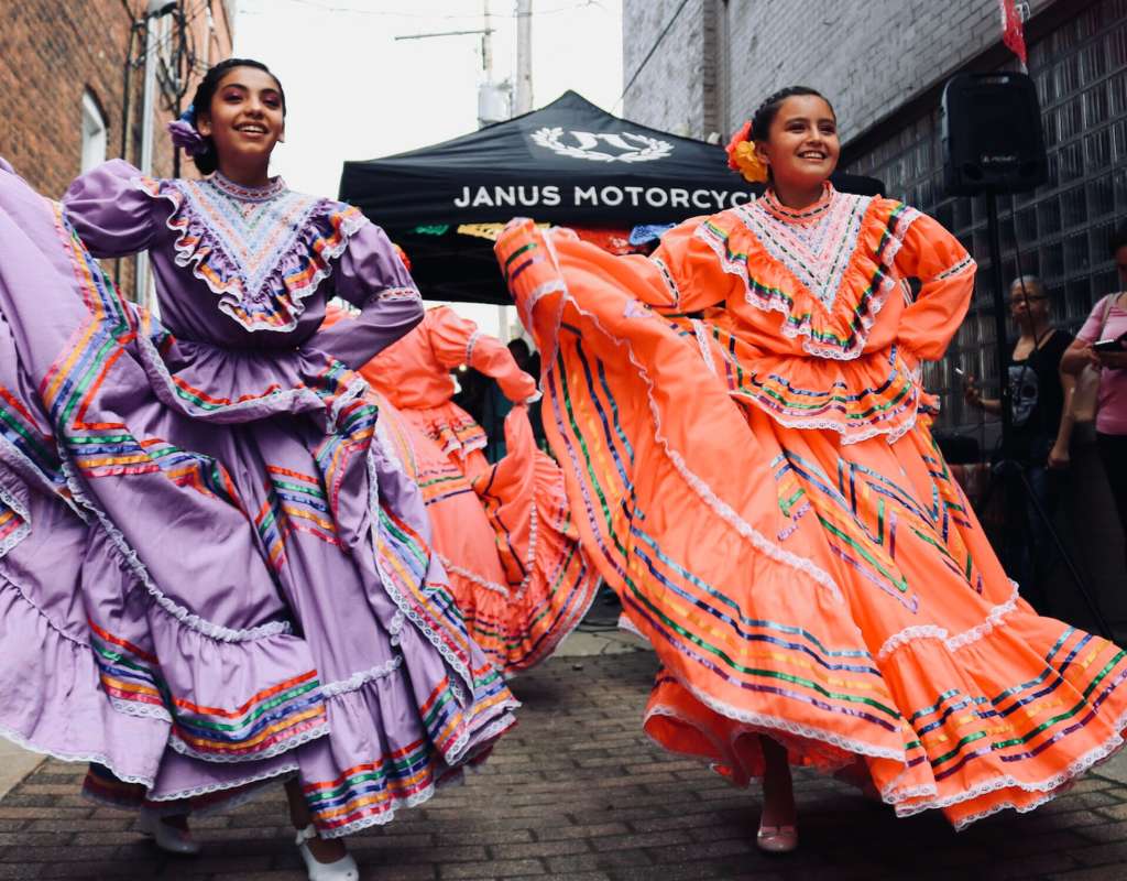 Women in the streets of Spain dancing during a festival