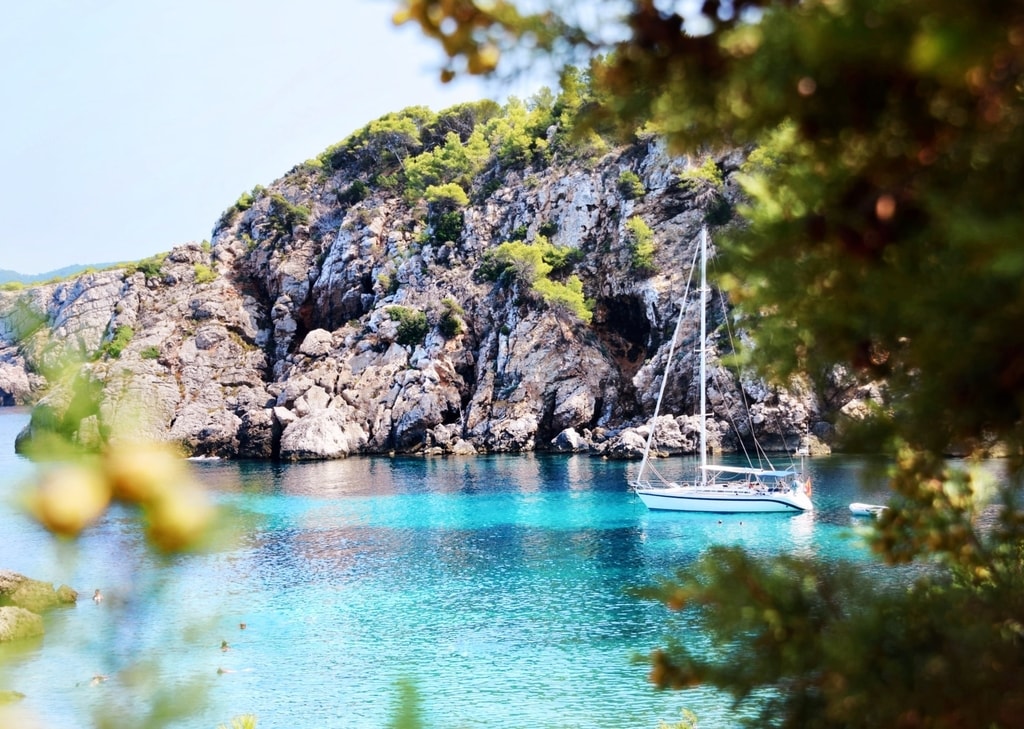 Yacht anchored in turquoise cove in Ibiza